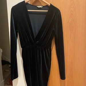 Emerald green velour cocktail dress with deep neckline.